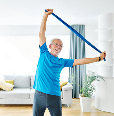 Woman using a flexa.fit resistance band for pilates and mobility at home