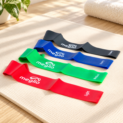 Four latex-free resistance loops on a cream exercise mat