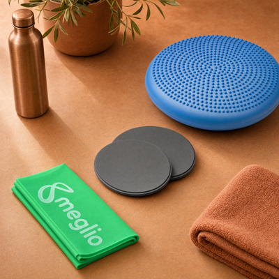 flexa.fit wobble cushion, core sliders and resistance band laid out with a water bottle and towel