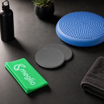 flexa.fit Core and Balance Kit on a dark surface, the wobble cushion with core sliders and a resistance band