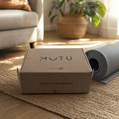 The MUTU Pack box on a living room floor next to a rolled yoga mat