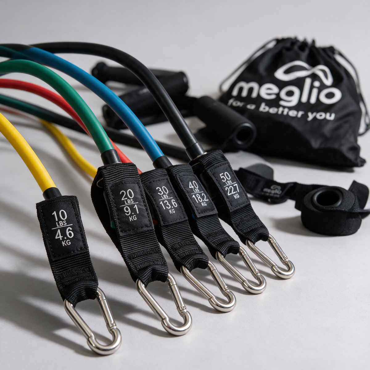 Close-up of the five resistance tube labels and metal clips beside the Meglio carry bag