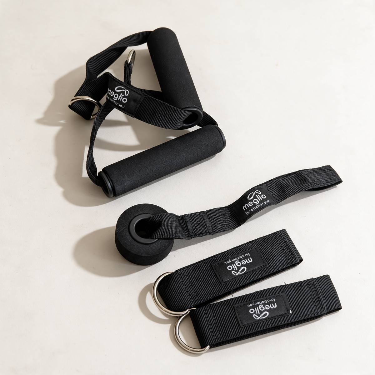 Meglio foam handles, two ankle straps and a door anchor on a neutral background