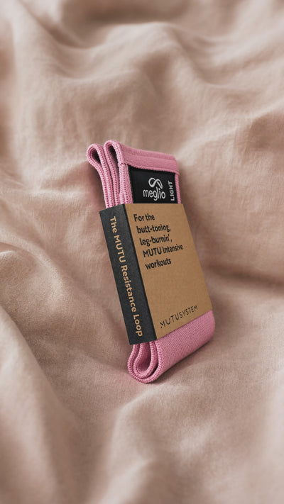 Close view of the pink MUTU Resistance Loop in its kraft sleeve